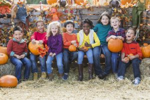 children with pumpkins at an Owensboro fall festival