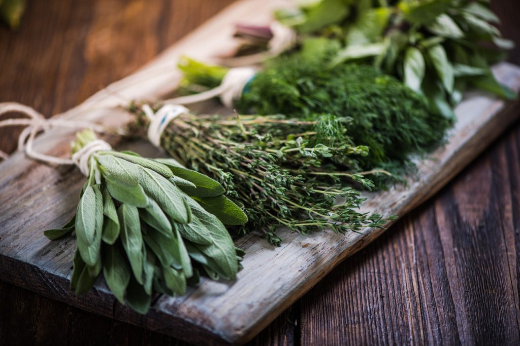 Herbs on a wooden board.