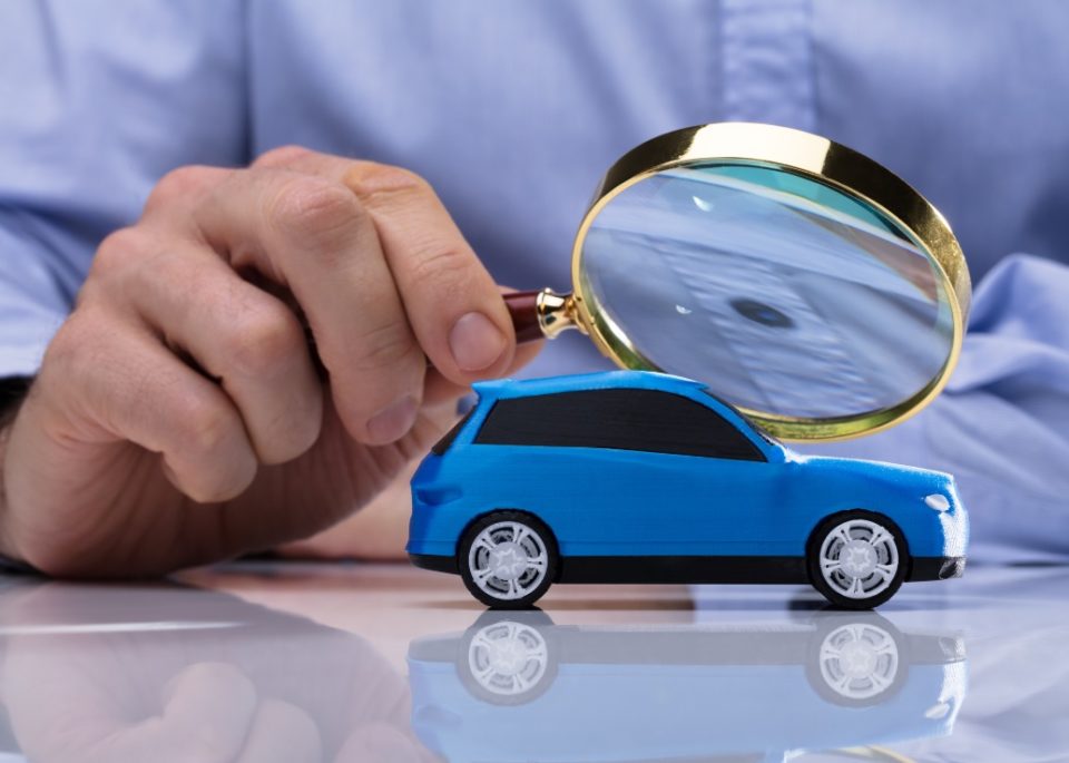 blue toy car under magnifying glass