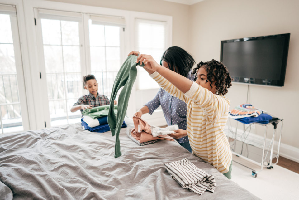 Mom and kids folding laundry