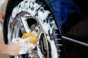 Cleaning tires with a sponge to make the tires shine